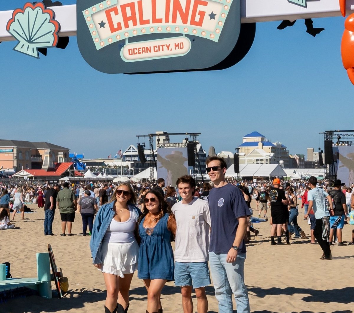 Group posing at a sign for Country Calling